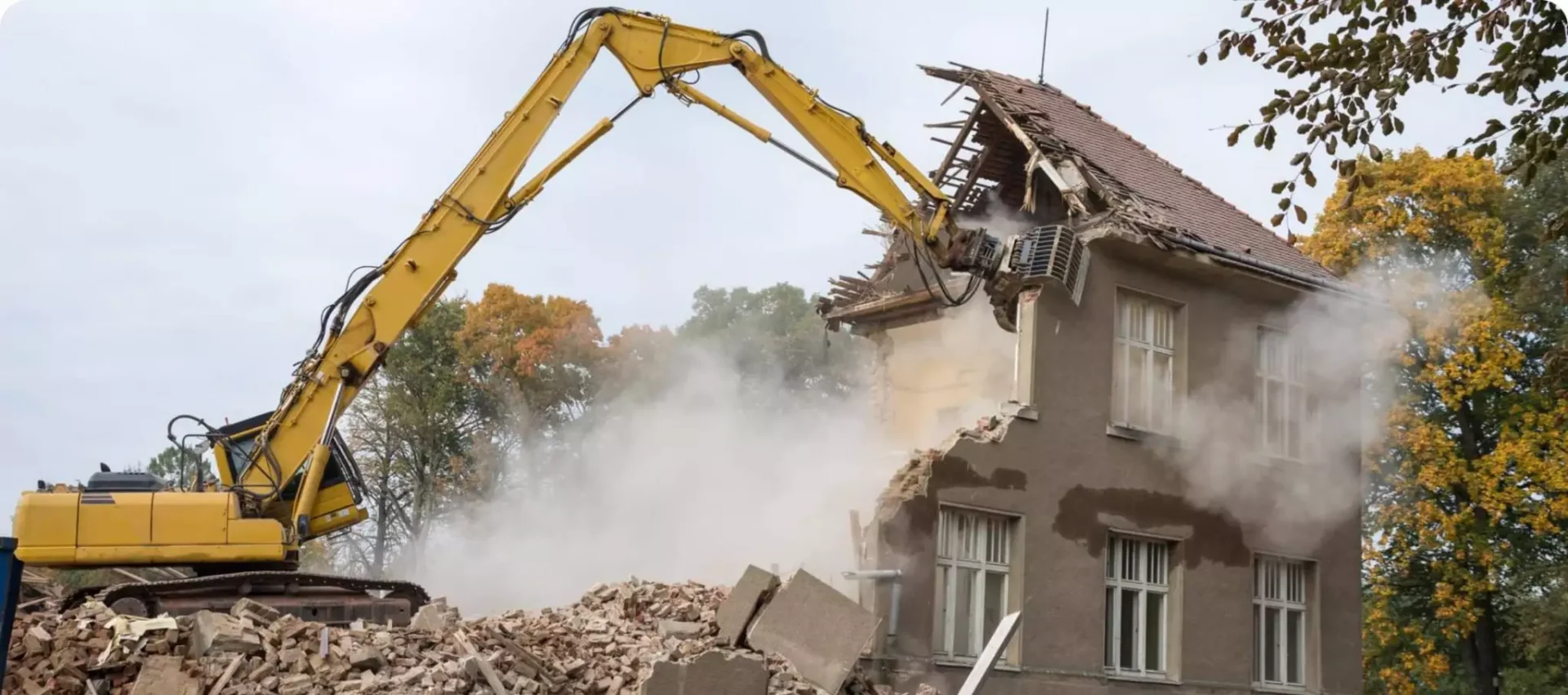 A yellow crane is in front of a building