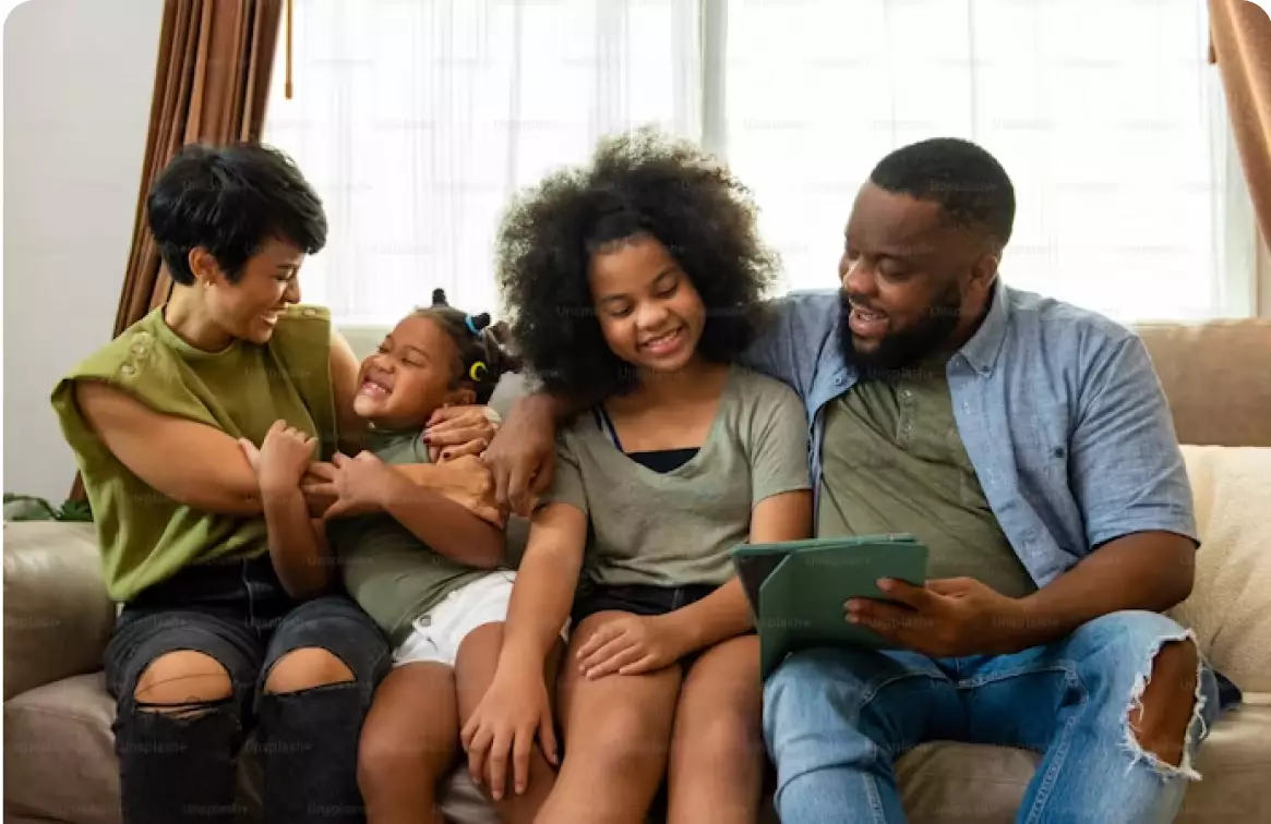 A group of people sitting on top of a couch.