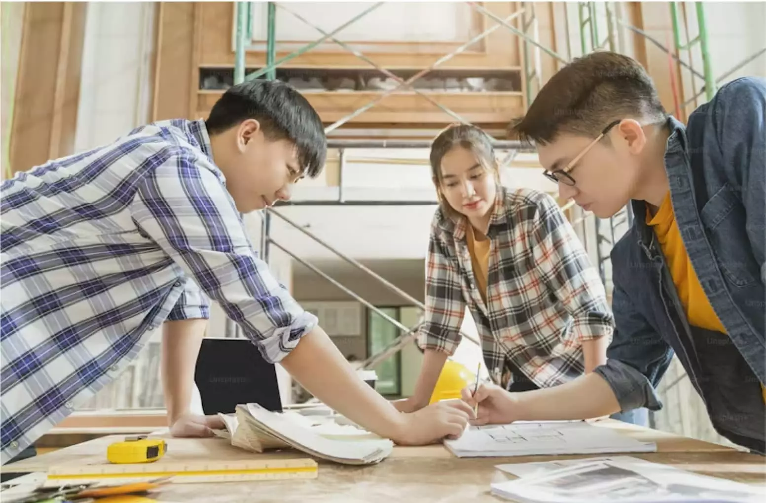 Three people are working on a project together.